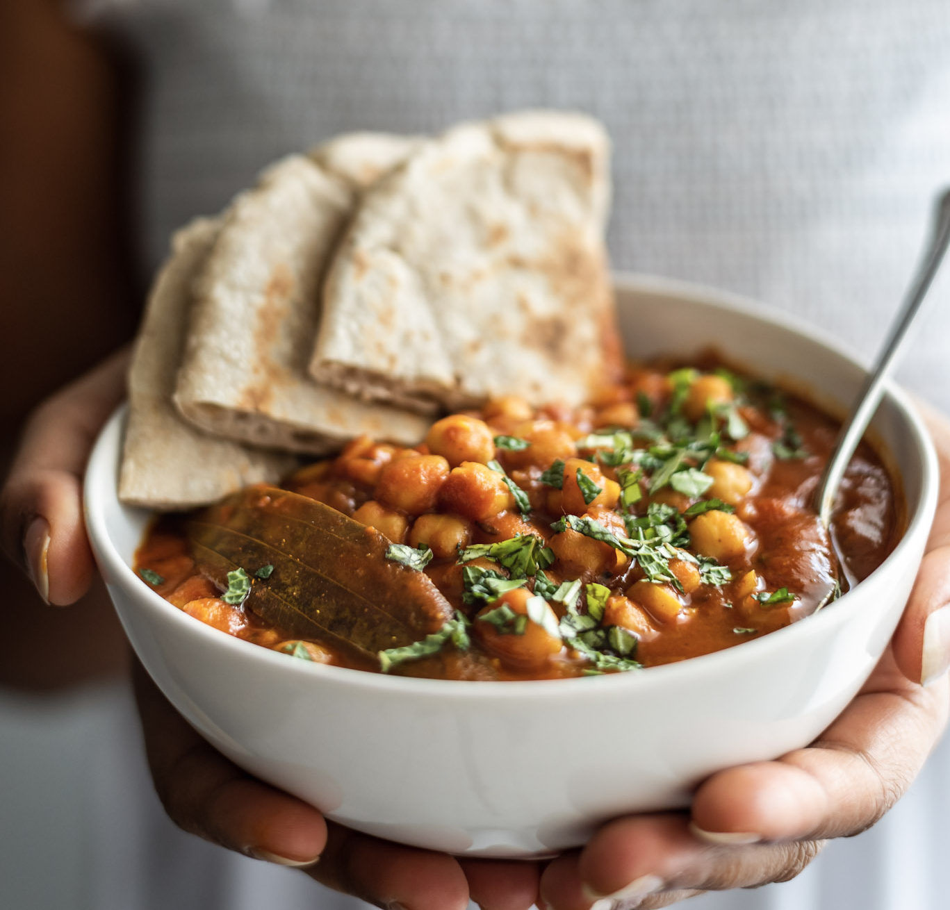 Holding a bowl of chana masala
