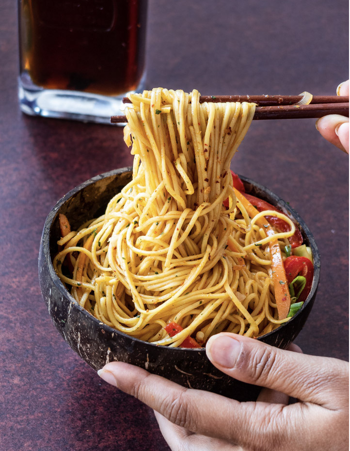 Chilli gqrlic noodles eaten with chopsticks