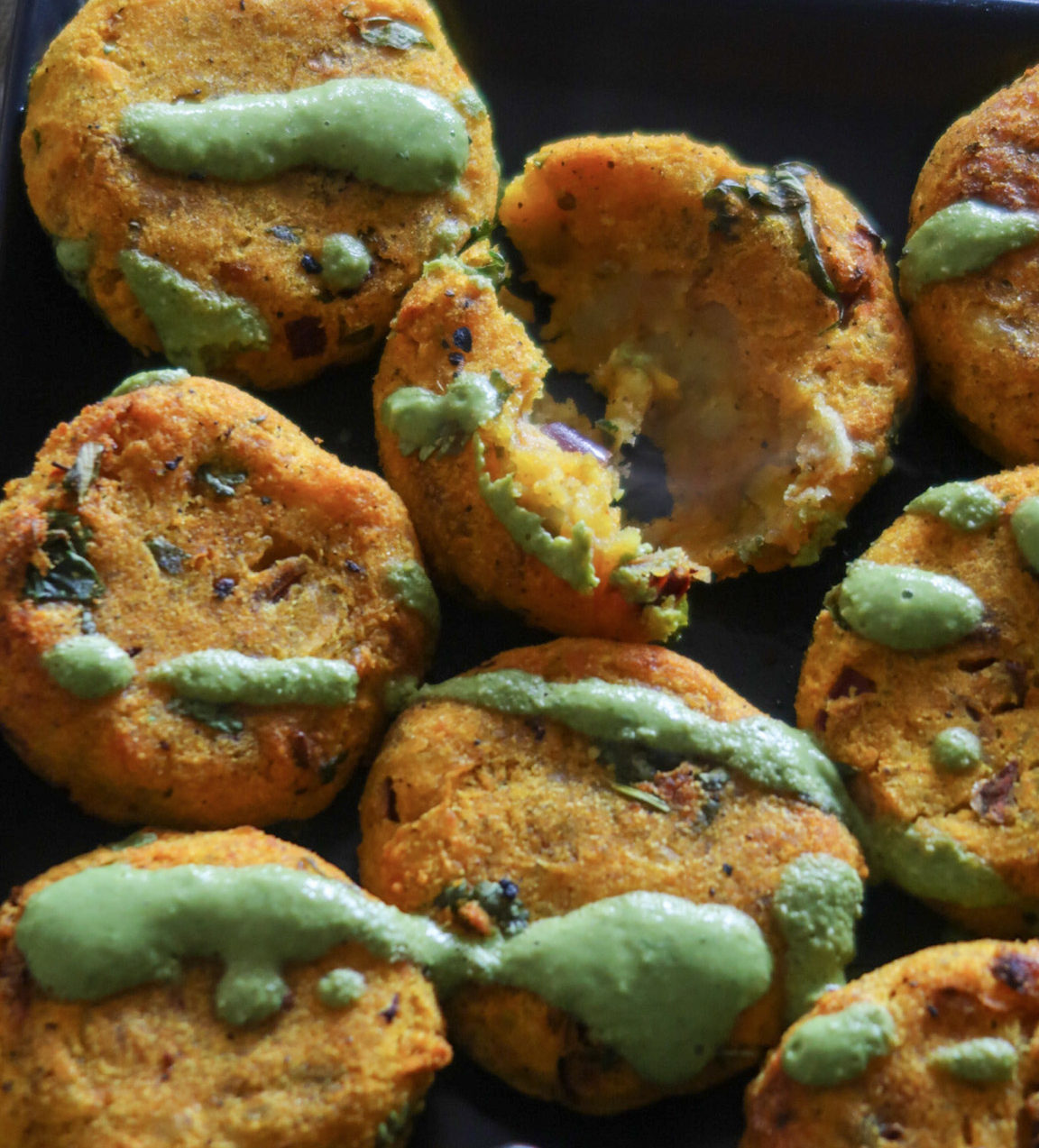 Aloo tikka served with chutney and yogurt