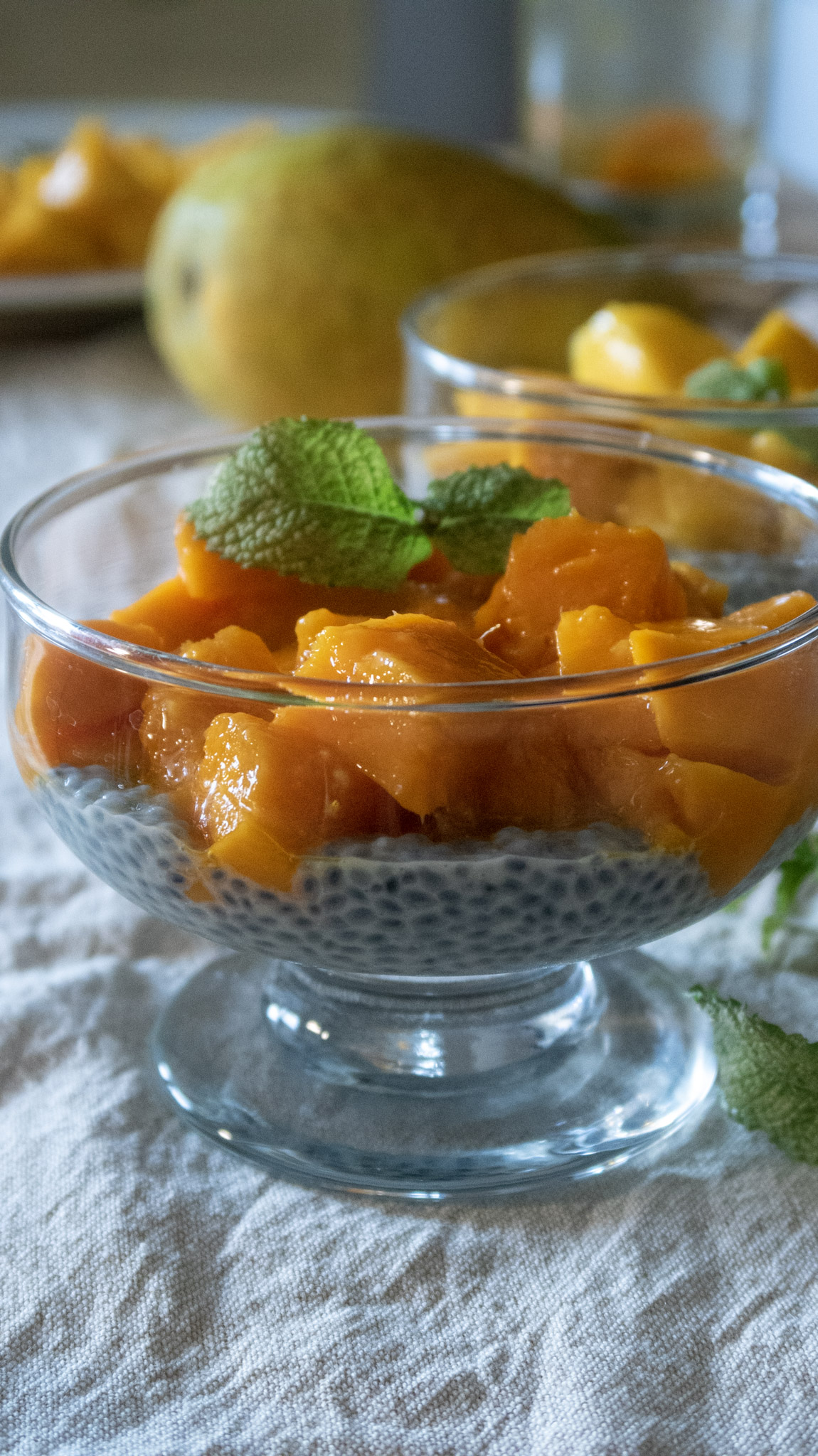 Mango basil seed pudding served in a glass dessert bowl, front shot