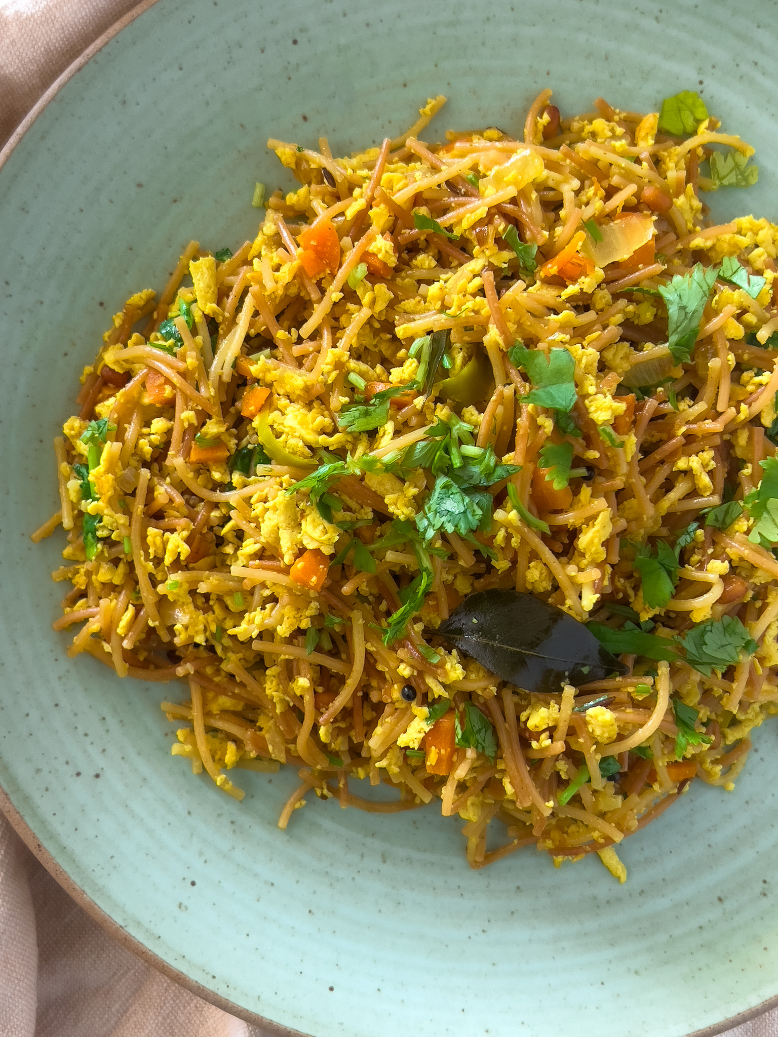 Tofu Vermicelli Upma served on a blue plate, top view