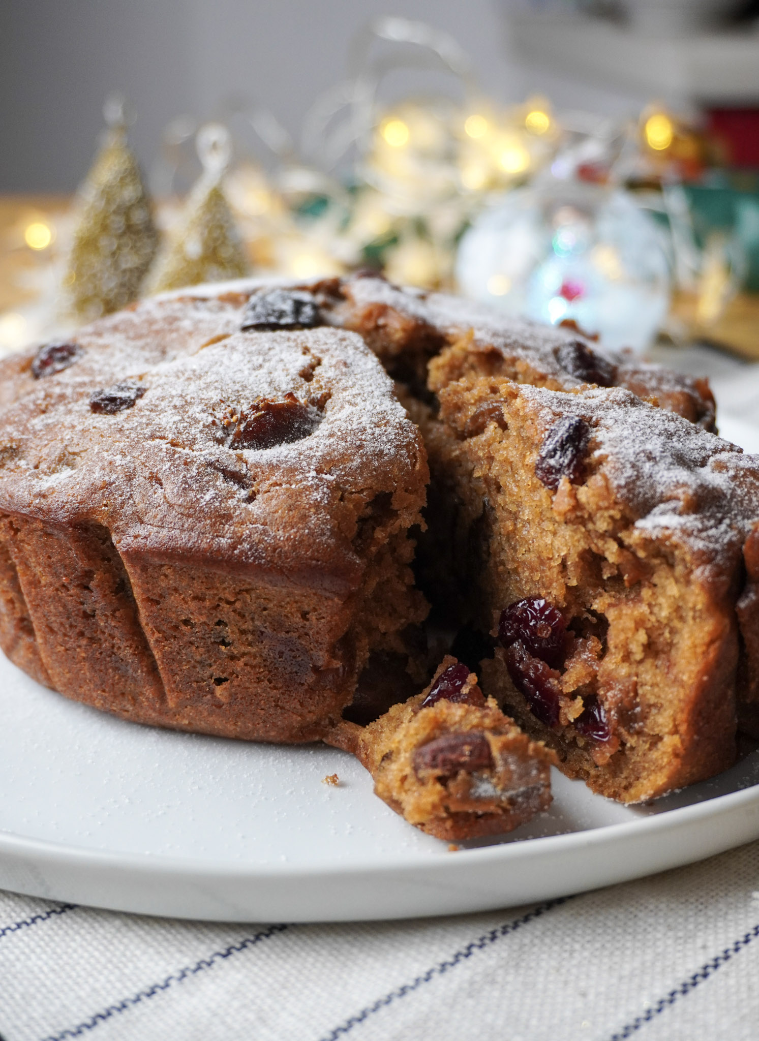 Vegan Plum Cake with a slice cut off on a plate