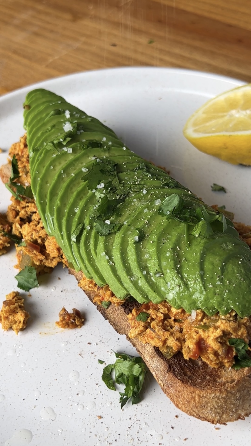 Garnishing the tofu bhurji with chopped coriander