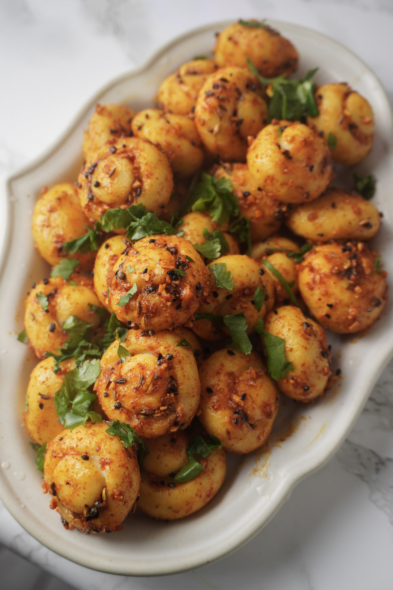 Spicy Potato dumplings, served on a white plate