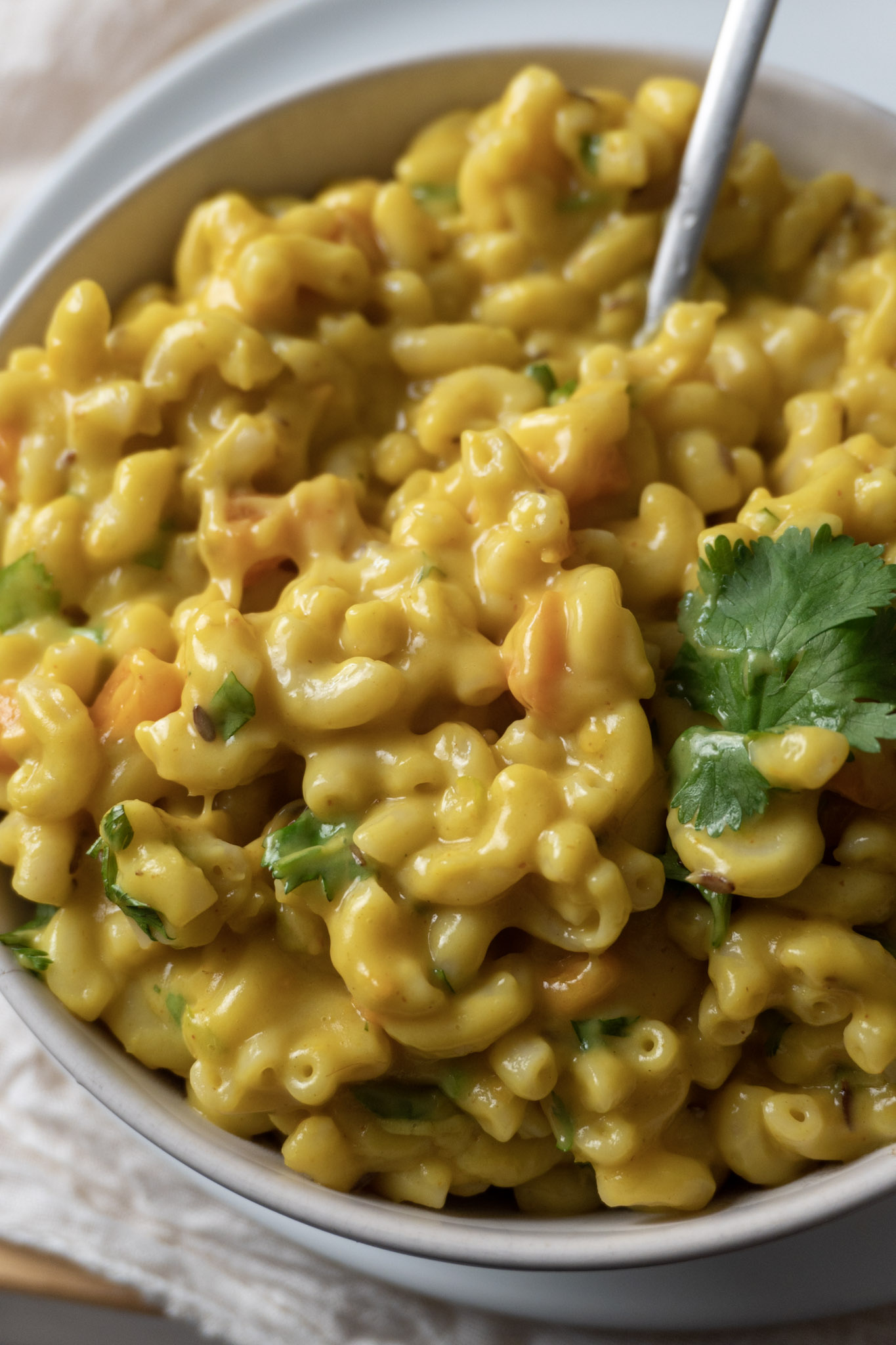 Vegan Spicy mac and cheese: Creamy macaroni and cheese dish with a spicy kick topped with cilantro