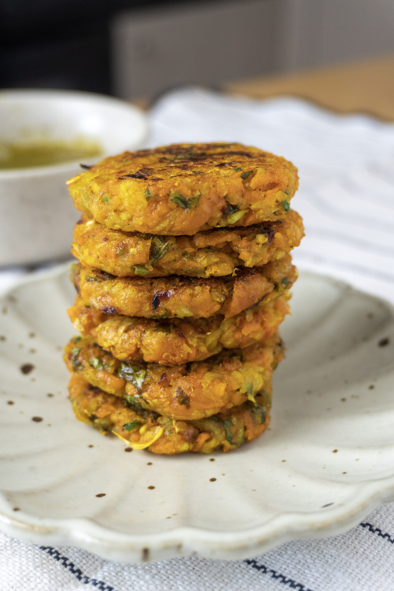 Spicy kohlrabi fritters stacked on a plate