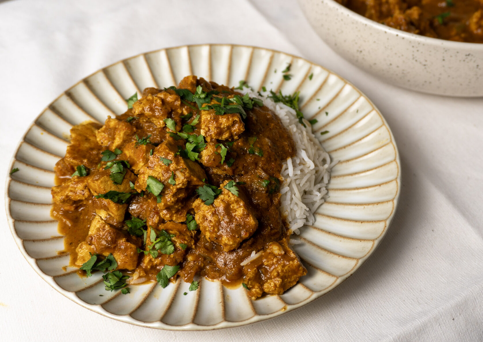 Tofu Vindaloo being served next to some steaming hot rice
