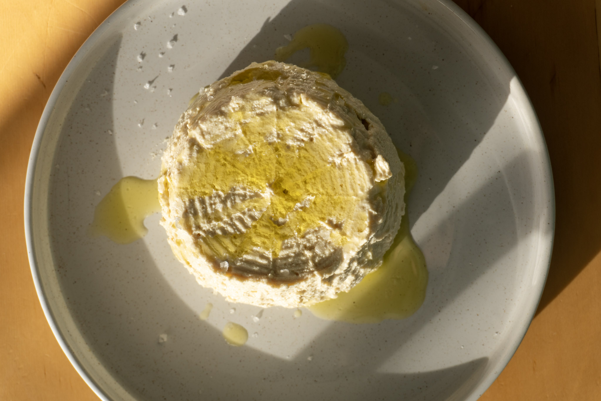 Tofu ricotta served on a plate. top view