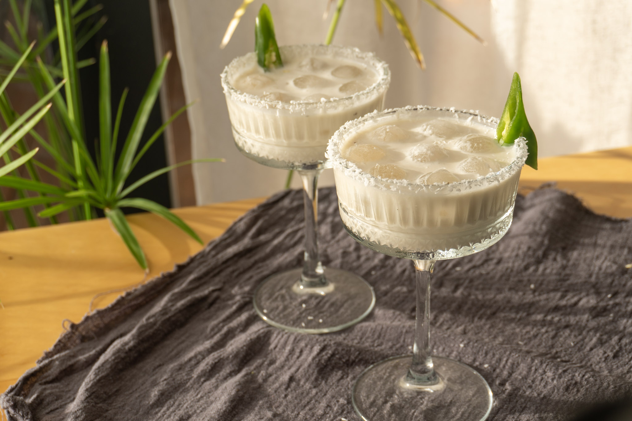 Smoky jalapeño coconut Mocktail served in 2 cocktail glasses, landscape view