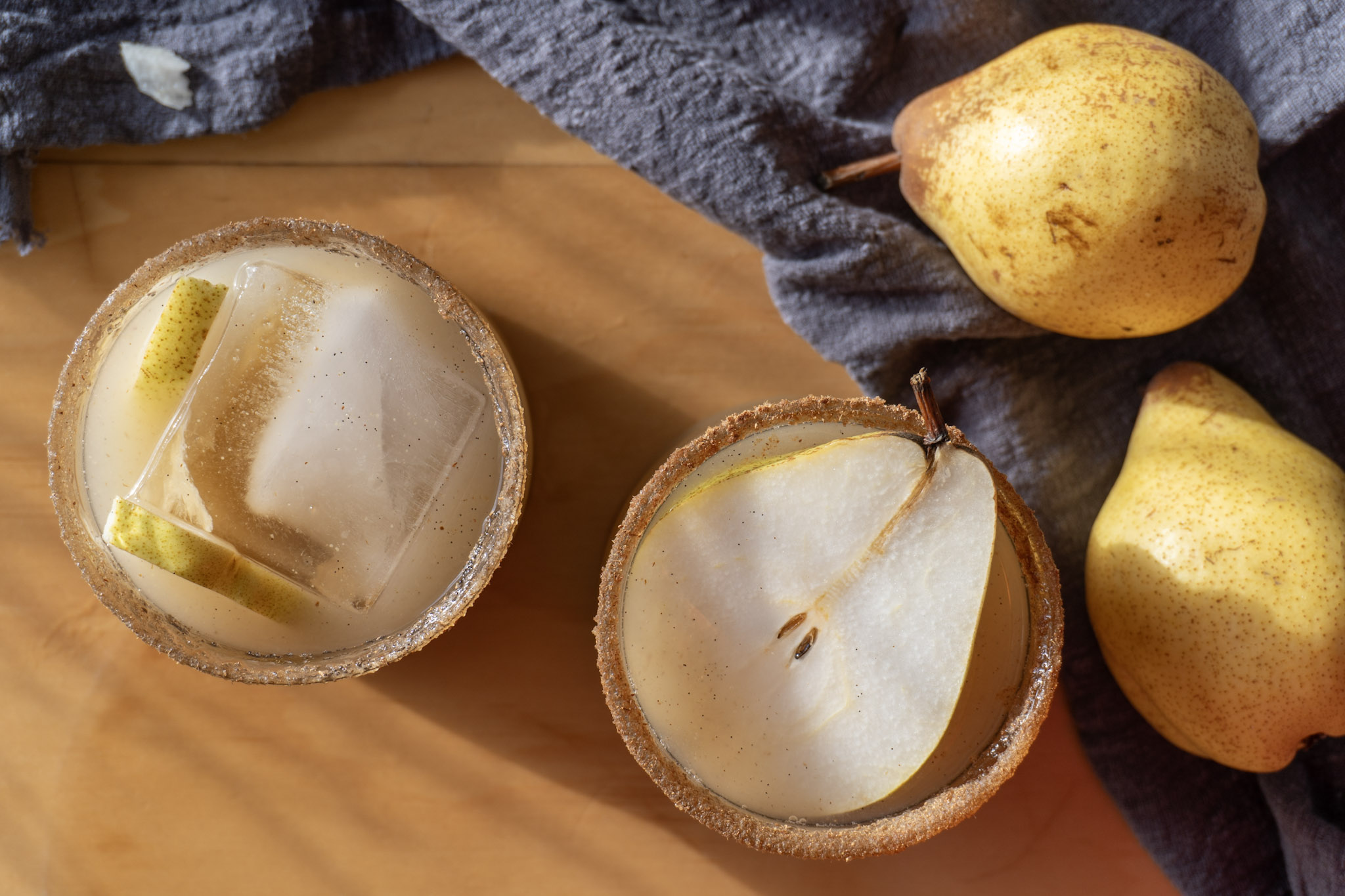 pear Vanilla mocktail served in 2 glasses garnished with a fresh pear. Top view