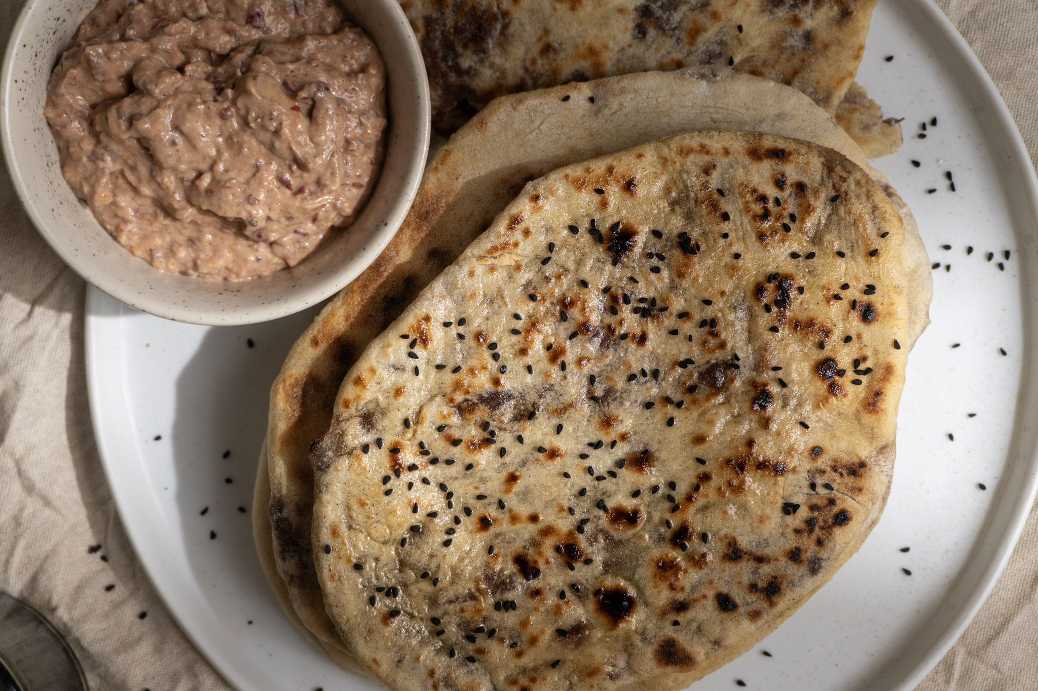 Top shot of caramelized onion stuffed naan served along with chutney