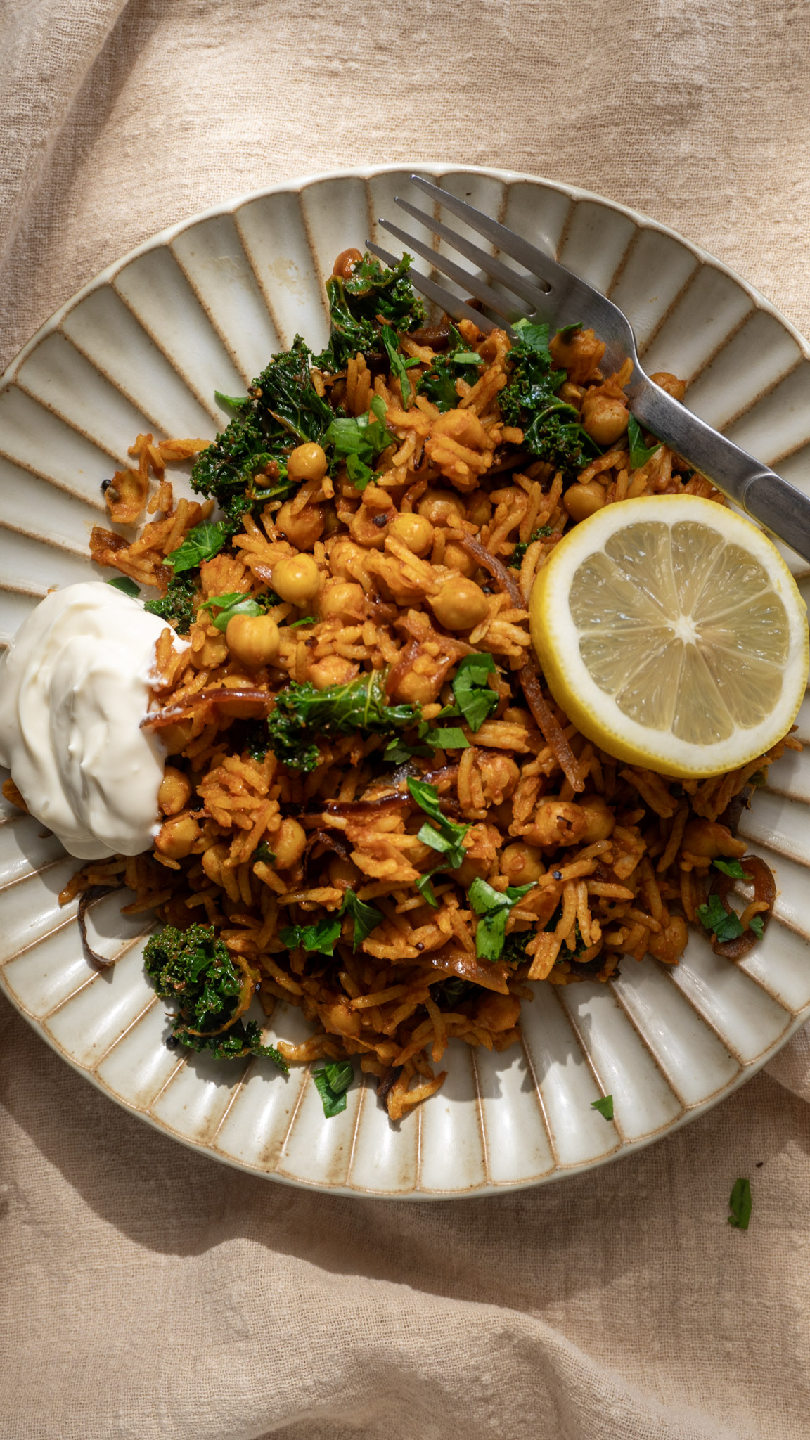 Top shot of chicpea tomato rice with kale and a side of yoghurt