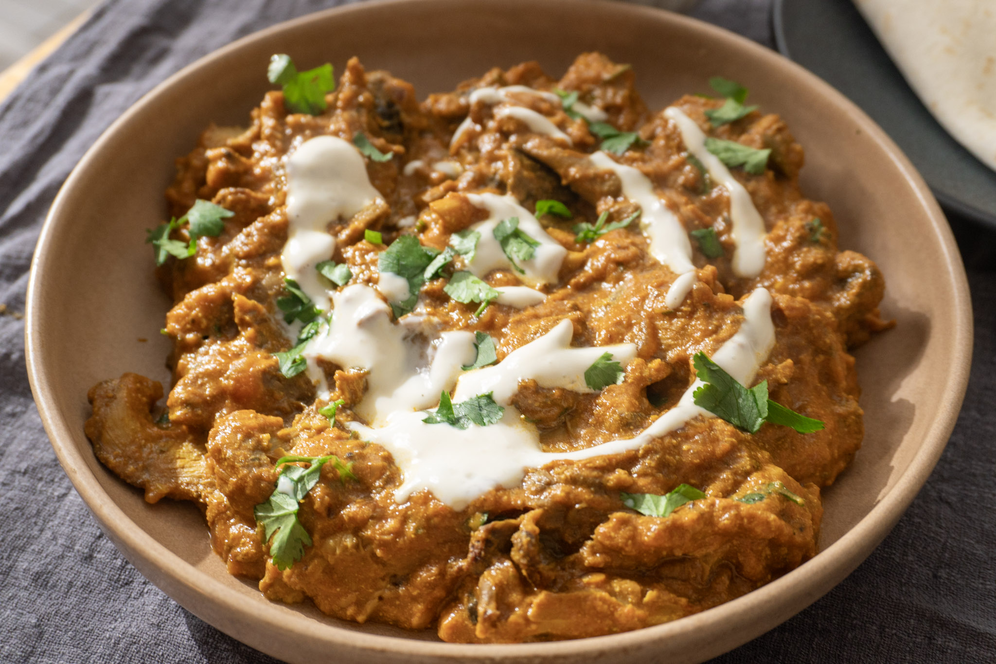 Side shot of Mushroom masala with silken tofu gravy in a bowl