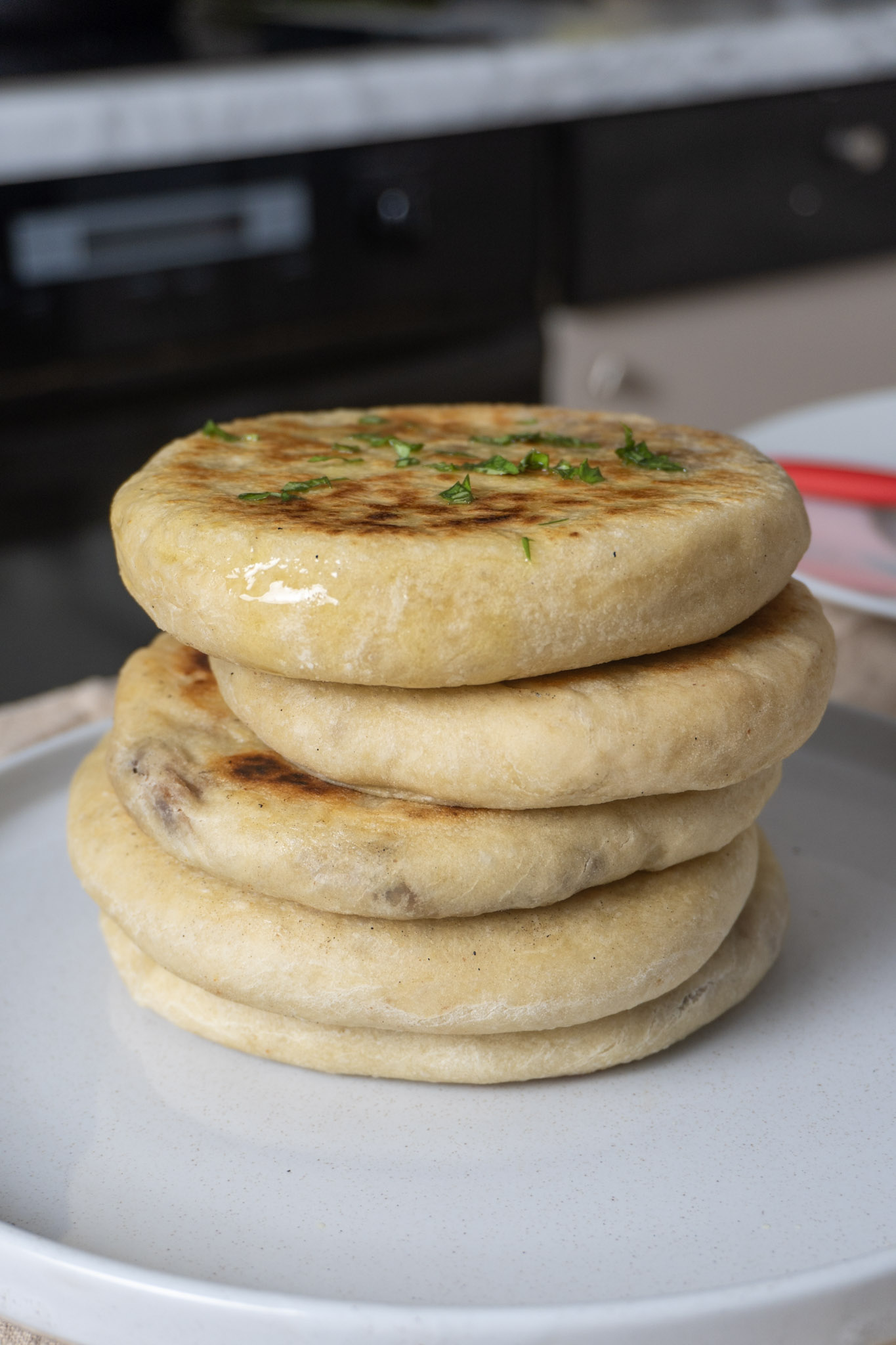 stack of vegan bean-stuffed pita recipe with chopped chives on top