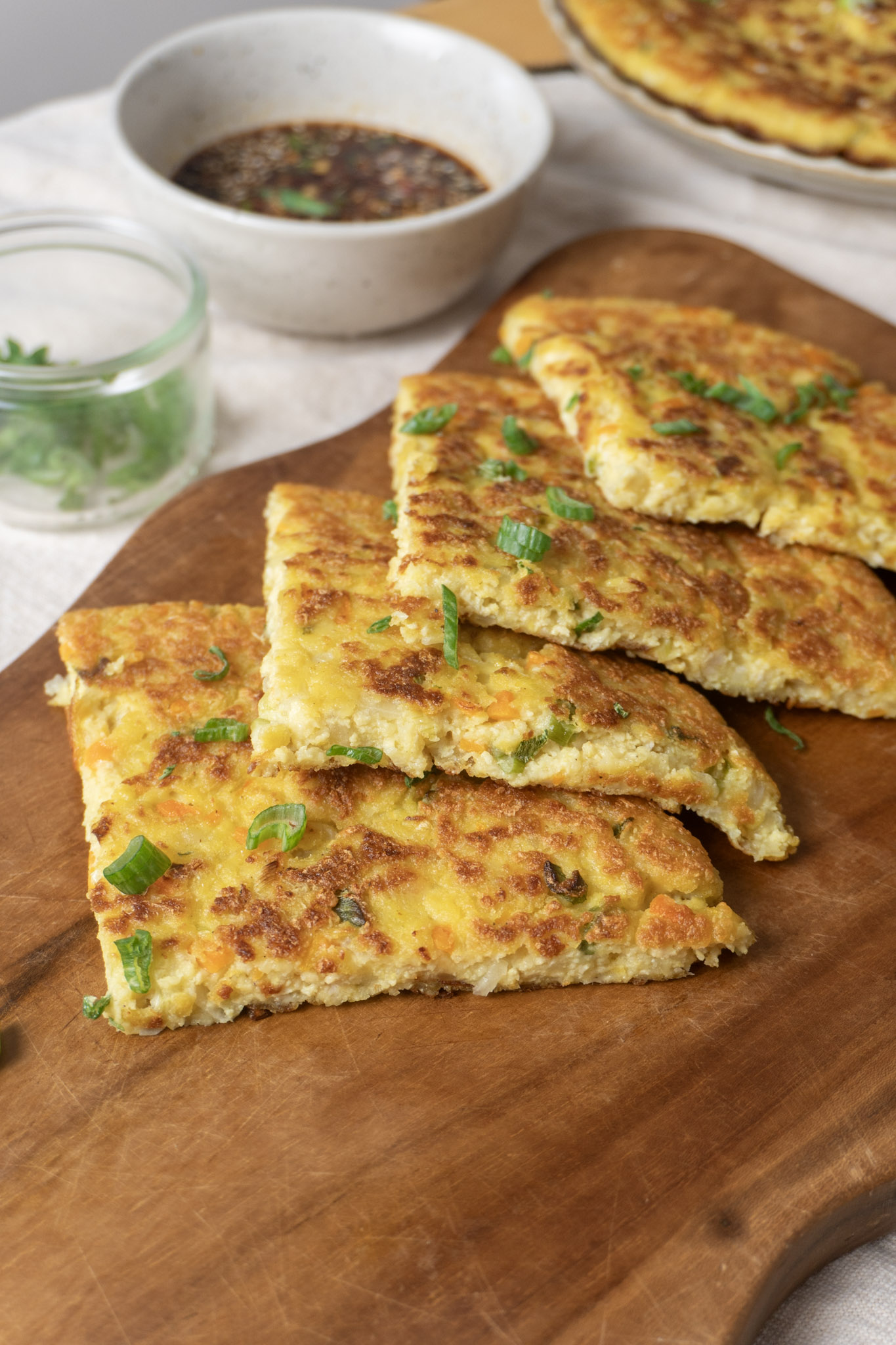 sliced tofu potato galette garnished with green onions